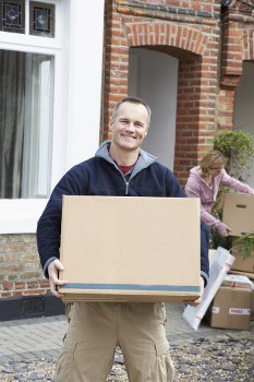 Workers loading furniture safely into a van