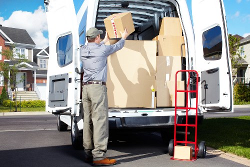 Specialist movers transporting a piano through a Richmond upon Thames home