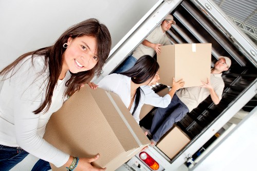Professional team collecting old household furniture for disposal